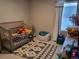 bedroom with crib, toys, and ample natural light at 429 Beckwourth Ave, Fort Lupton, CO 80621