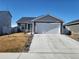 Ranch-style home with a two-car garage and landscaped yard at 429 Beckwourth Ave, Fort Lupton, CO 80621