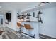 Finished basement bar with a reclaimed wood facade, pipe shelving, and seating at 25525 E 1St Ave, Aurora, CO 80018