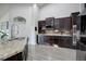 Kitchen with dark cabinetry, stainless steel appliances, and a granite countertop at 25525 E 1St Ave, Aurora, CO 80018