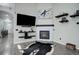 Inviting living room with a fireplace, mounted TV, and floating shelves for a modern touch at 25525 E 1St Ave, Aurora, CO 80018