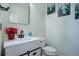 Charming powder room with a white vanity, black fixtures, and decorative accents at 25525 E 1St Ave, Aurora, CO 80018