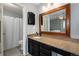 Ensuite bathroom features a granite countertop vanity with framed mirror and a shower-tub combo at 8873 Yukon St, Broomfield, CO 80021