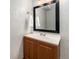 Bathroom featuring vanity with wood cabinets, bright lighting, and large mirror at 8873 Yukon St, Broomfield, CO 80021