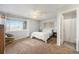 Bright bedroom with a ceiling fan, cozy chair, neutral decor and an adjoining bathroom at 8873 Yukon St, Broomfield, CO 80021
