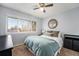 Cozy bedroom featuring a ceiling fan, large window, and tree-inspired wall decor at 8873 Yukon St, Broomfield, CO 80021