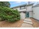 Charming townhome with a blue front door and well-maintained landscaping at 8873 Yukon St, Broomfield, CO 80021