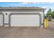 Exterior shot of a one-car garage with white door on a home featuring a gray trim at 8873 Yukon St, Broomfield, CO 80021