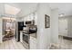 Bright kitchen features a skylight, black appliances, granite countertops, and access to the dining room at 8873 Yukon St, Broomfield, CO 80021