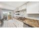 Well-lit kitchen features granite countertops, stainless steel appliances, and a sliding door to the outdoors at 8873 Yukon St, Broomfield, CO 80021