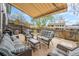 Cozy outdoor patio area with wicker furniture and retractable awning at 8873 Yukon St, Broomfield, CO 80021