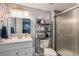 A newly renovated bathroom featuring updated lighting fixtures, vanity, and a sleek glass door shower at 10144 Madison St, Thornton, CO 80229