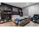 Teen bedroom with poster-covered walls, dark carpet, and modern furniture at 10144 Madison St, Thornton, CO 80229