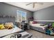 bedroom features two twin beds, a desk, and gray walls and carpet at 10144 Madison St, Thornton, CO 80229