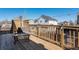 Private deck with wooden railing offers ample space for outdoor seating and entertaining, with a view of neighboring homes at 10144 Madison St, Thornton, CO 80229