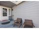 Cozy covered front porch with seating area provides a warm welcome at 10144 Madison St, Thornton, CO 80229
