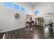 Bright living room features vaulted ceilings, an oversized clock, and dark hardwood floors at 10144 Madison St, Thornton, CO 80229