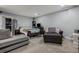 Carpeted living room showcases a well-organized space with a TV, seating, and dark wood accents at 10144 Madison St, Thornton, CO 80229