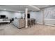 A spacious living room boasts neutral tones, a large sectional, and barstool seating by the support beam at 10144 Madison St, Thornton, CO 80229