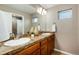 Bathroom featuring a double vanity with granite countertops and sleek fixtures, enhanced by natural light at 787 Kendall Ct, Lakewood, CO 80214