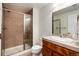 Bathroom featuring a tiled shower, neutral tones, and a single vanity at 787 Kendall Ct, Lakewood, CO 80214