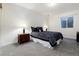 Bedroom featuring neutral tones, soft carpet, and an egress window at 787 Kendall Ct, Lakewood, CO 80214