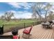 Large outdoor deck featuring lounge seating and a fire pit, perfect for enjoying the golf course views at 787 Kendall Ct, Lakewood, CO 80214