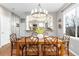 Elegant dining room with a chandelier and wood table, adjacent to the kitchen and living area at 787 Kendall Ct, Lakewood, CO 80214