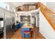 Bright, open kitchen with a large island, stainless appliances, and a staircase visible in the background at 787 Kendall Ct, Lakewood, CO 80214