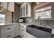 Kitchen features a farmhouse sink and white shaker cabinets at 4969 S Indian Trl, Evergreen, CO 80439