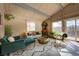 Bright living room with wood-paneled walls and deck access at 4969 S Indian Trl, Evergreen, CO 80439