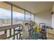 Enclosed balcony featuring exercise equipment, furniture, storage and an outside view at 625 S Alton Way # 3D, Denver, CO 80247