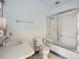 Bathroom with a glass shower door, white toilet, sink, towel bar, and light blue walls at 625 S Alton Way # 3D, Denver, CO 80247