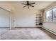 Bedroom with neutral carpet, ceiling fan, closet with mirror doors, shelves, and large window at 625 S Alton Way # 3D, Denver, CO 80247