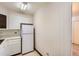 Galley kitchen featuring white appliances and ample cabinet space, with classic wallpaper at 625 S Alton Way # 3D, Denver, CO 80247