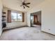 Living room with carpet, shelving, large window, and slider to the outside at 625 S Alton Way # 3D, Denver, CO 80247