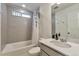 Clean and modern bathroom featuring a shower/tub combo with stylish shower curtain and a mirrored vanity at 3963 N Quatar Ct, Aurora, CO 80019