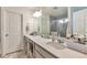 Spacious bathroom featuring a double vanity with quartz countertop and framed mirror, plus a glass-enclosed shower at 3963 N Quatar Ct, Aurora, CO 80019