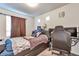 This cozy bedroom features a bed with drawer storage and natural light from a bright window at 3963 N Quatar Ct, Aurora, CO 80019