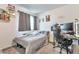 This bedroom features a cozy bed, decorative wall art, and a functional desk area, perfect for studying at 3963 N Quatar Ct, Aurora, CO 80019