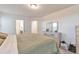 Bright bedroom with an elegant dresser and mirror, complemented by cozy bedding and fresh, white trim at 3963 N Quatar Ct, Aurora, CO 80019