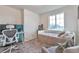 Bedroom includes a daybed, comfy armchair, and a dedicated workspace, all bathed in natural light at 3963 N Quatar Ct, Aurora, CO 80019