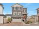 Charming two-story home featuring a red door, brick driveway, and a well-maintained front yard at 3963 N Quatar Ct, Aurora, CO 80019