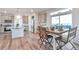 Bright kitchen and dining area featuring a breakfast nook, kitchen island, and wood flooring at 3963 N Quatar Ct, Aurora, CO 80019