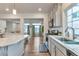 Open-concept kitchen with stainless steel appliances, flowing into a cozy living area with wood floors at 3963 N Quatar Ct, Aurora, CO 80019