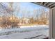 Backyard with bare trees, a small brick wall, and snow on the ground at 4855 Edison Ave # 112, Boulder, CO 80301