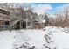 Home exterior showing a snowy backyard and exterior stairs to the back entrance at 4855 Edison Ave # 112, Boulder, CO 80301