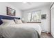Bright bedroom featuring a plush bed, large window with natural light, and calming decor at 4855 Edison Ave # 112, Boulder, CO 80301