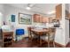 Bright dining area with a wooden table, seating for four, and a view into the adjacent kitchen at 4855 Edison Ave # 112, Boulder, CO 80301