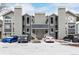 Modern condo building with covered parking and snowy front lot and beautiful blue and gray exterior at 4855 Edison Ave # 112, Boulder, CO 80301